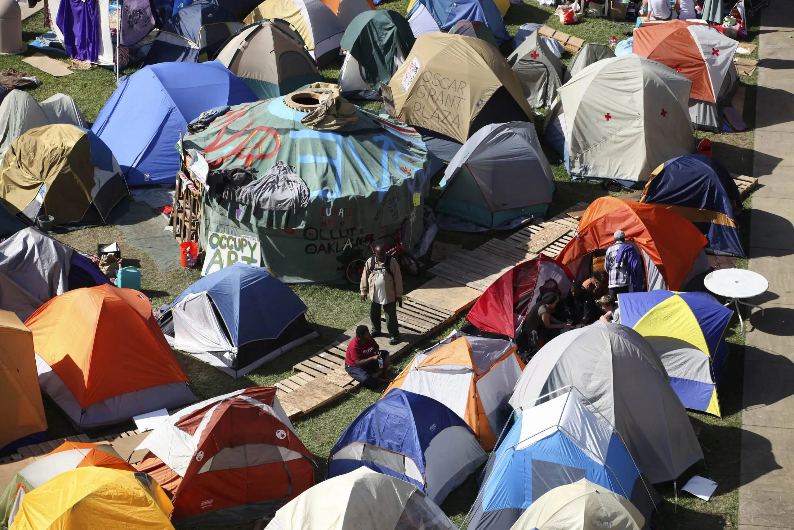People walk among tents at the Occupy Oakland protest in October 2011.