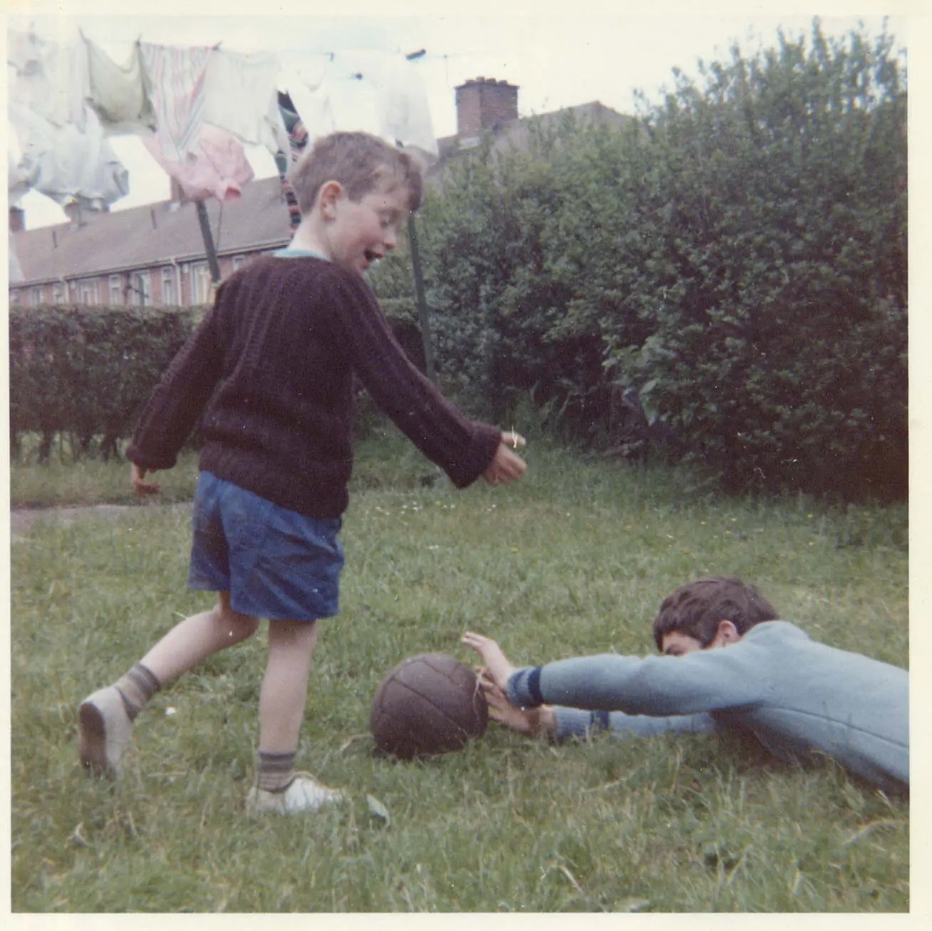 Richard Moore plays soccer with his brother Noel in their yard..
