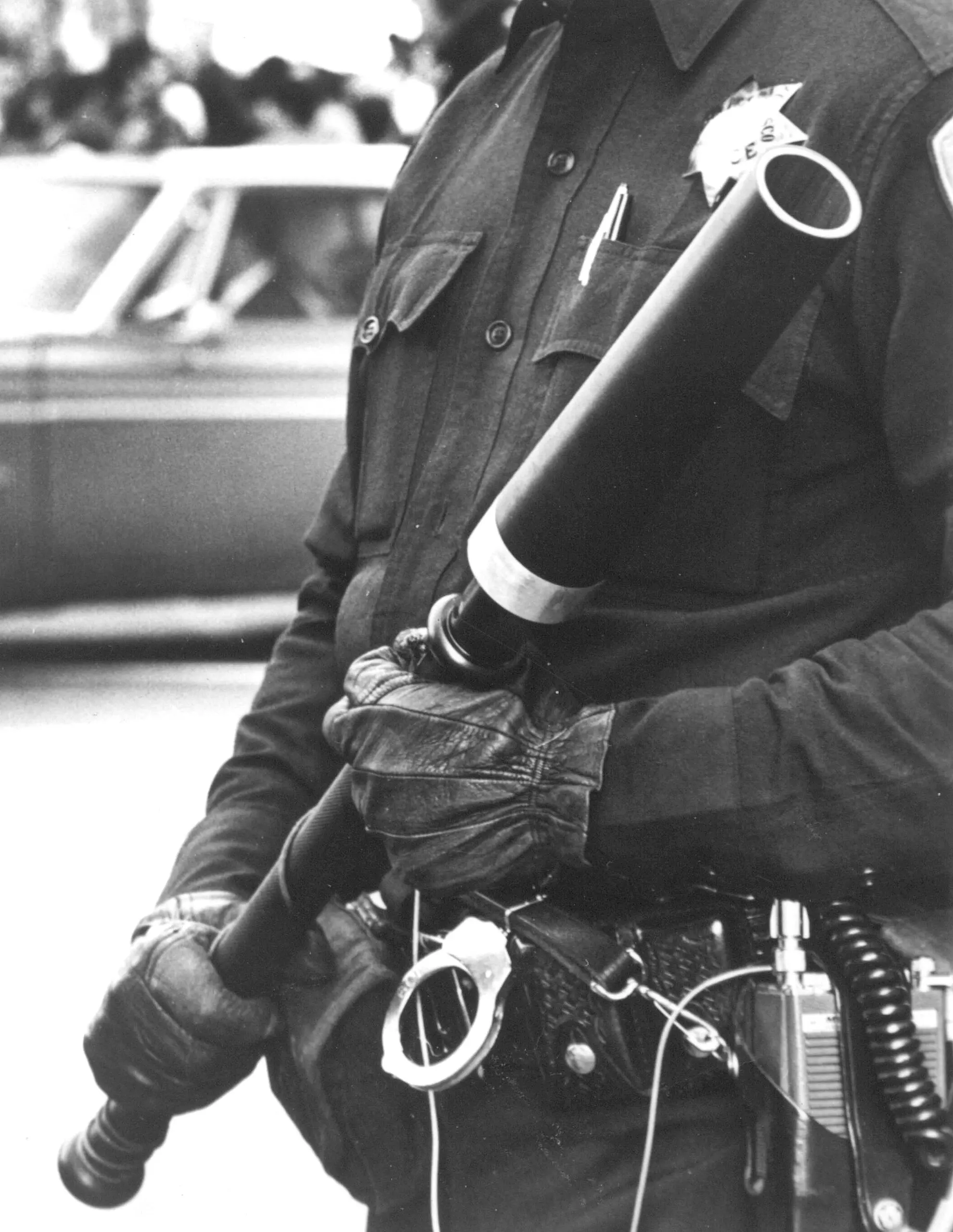 A law enforcement officer holding a prototype MB Associates Stun-Gun stands watch during anti-war demonstrations on December 1, 1970 in San Francisco.