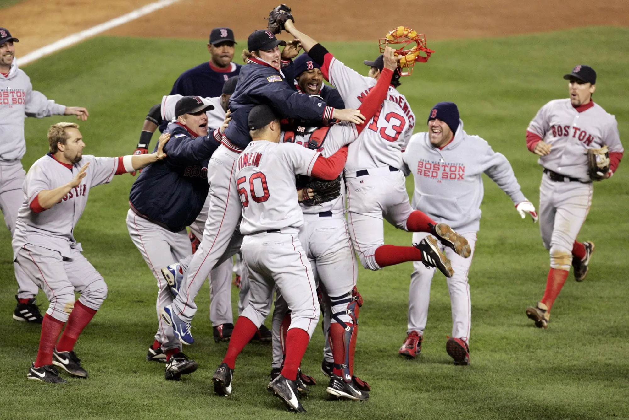 Red Sox players storm the field at Yankee Stadium after defeating New York to win the 2004 American League championship.