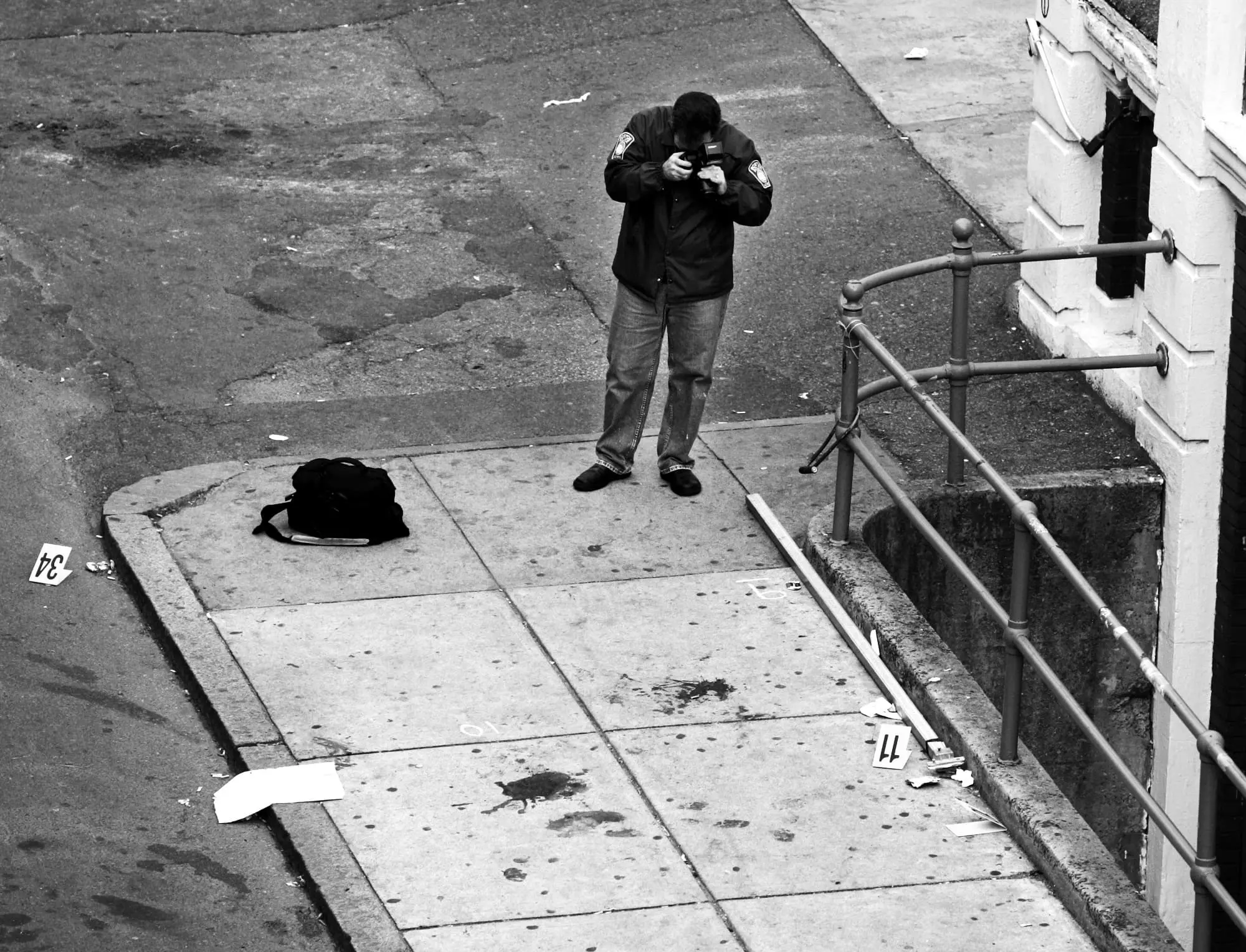 A Boston Police detective photographs the crime scene outside Fenway Park where Snelgrove was killed by an officer firing a less-lethal weapon.