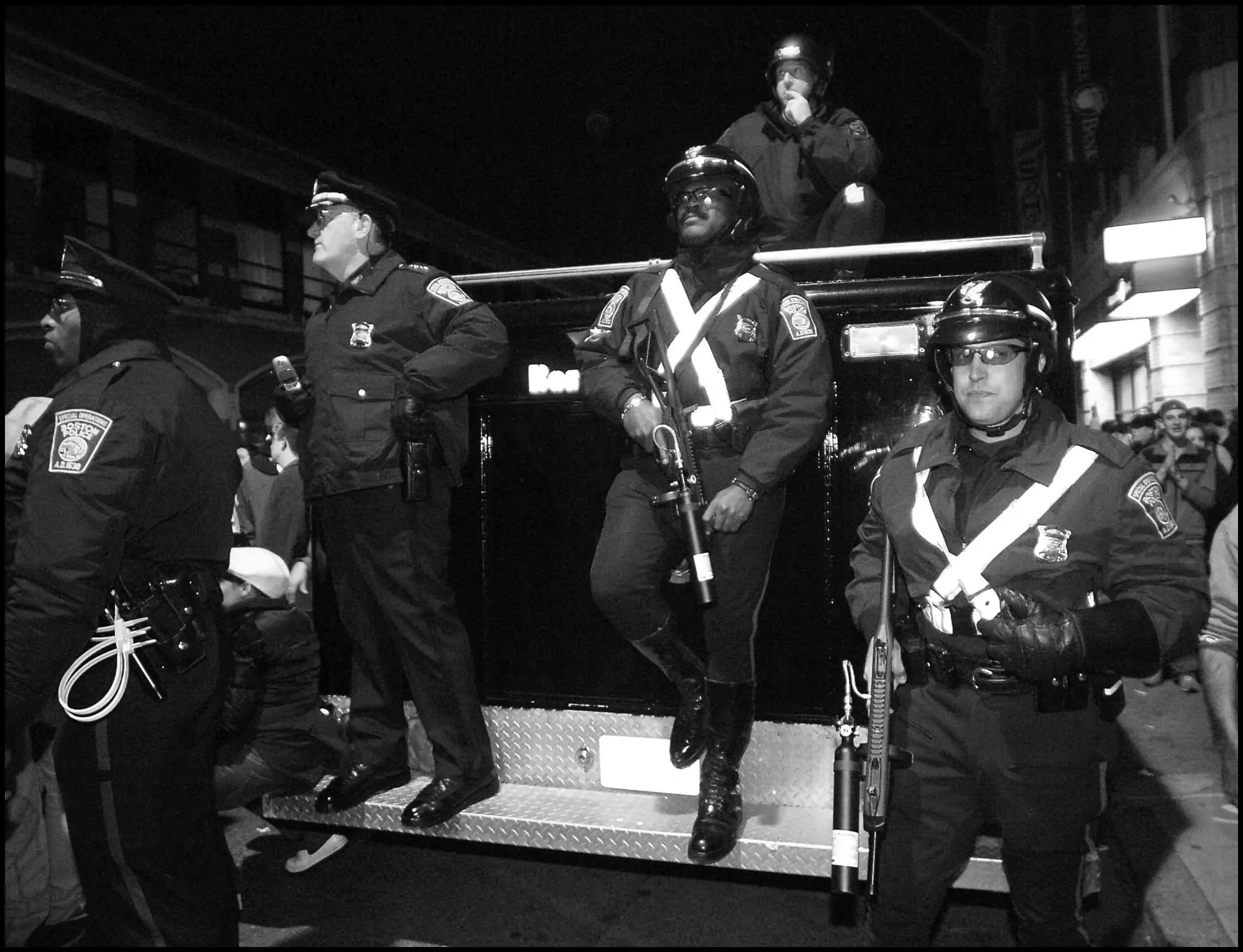 Commander Robert O'Toole (second from left) stands outside Fenway Park with officers who appear to be Rochefort Milien (center) and Samir Silta (right) holding FN303 pepper ball guns.