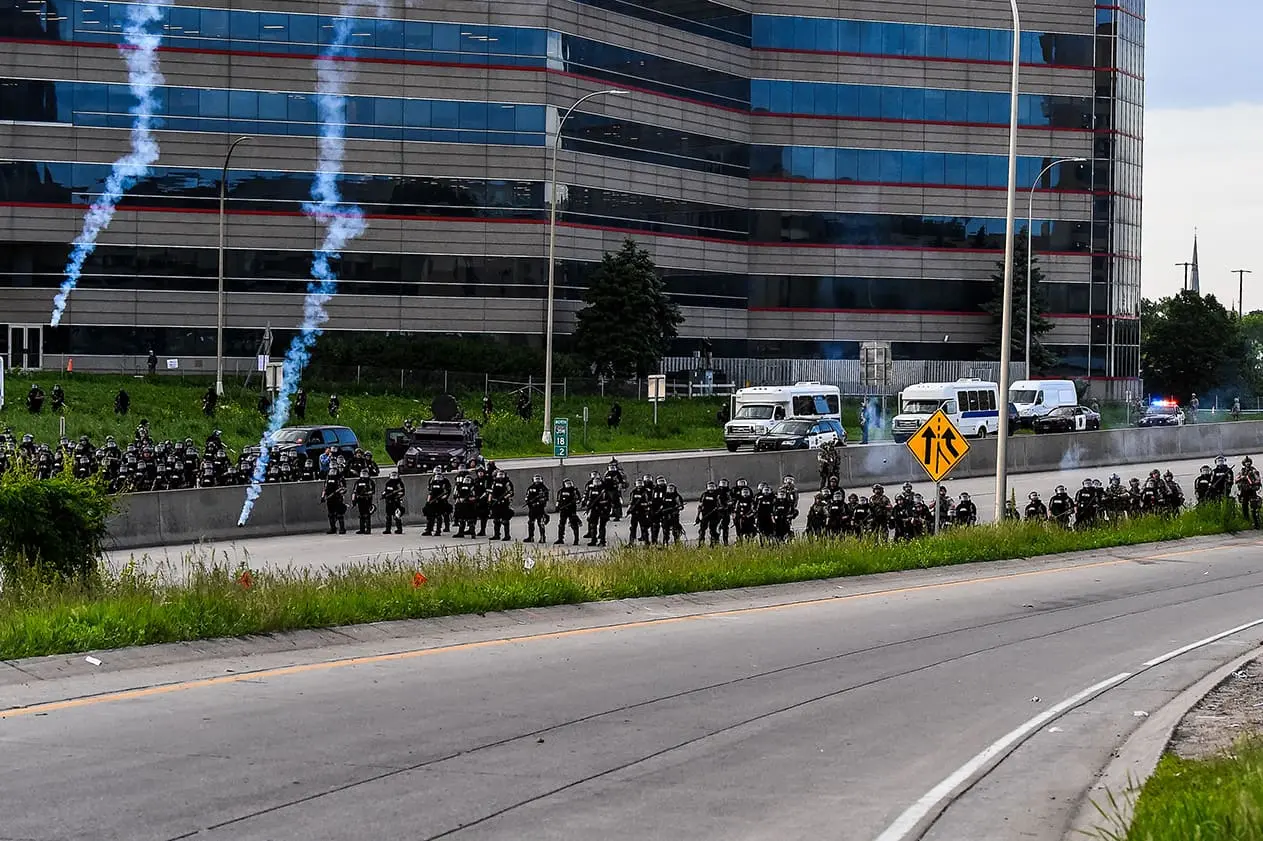 Minneapolis Police block access to Interstate 35W as they fire kinetic impact projectiles and tear gas towards demonstrators during a protest on May 31, 2020. Soren Stevenson is partially blinded by one of their shots.