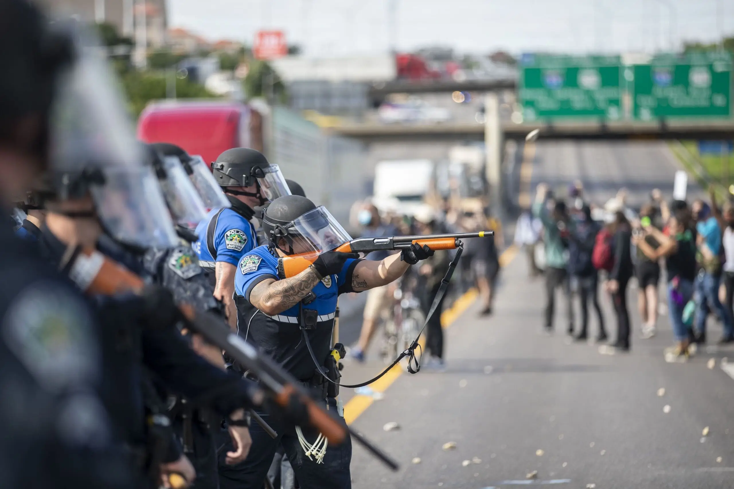 An Austin Police officer fires bean-bag rounds into a crowd of protesters on May 30, 2020.